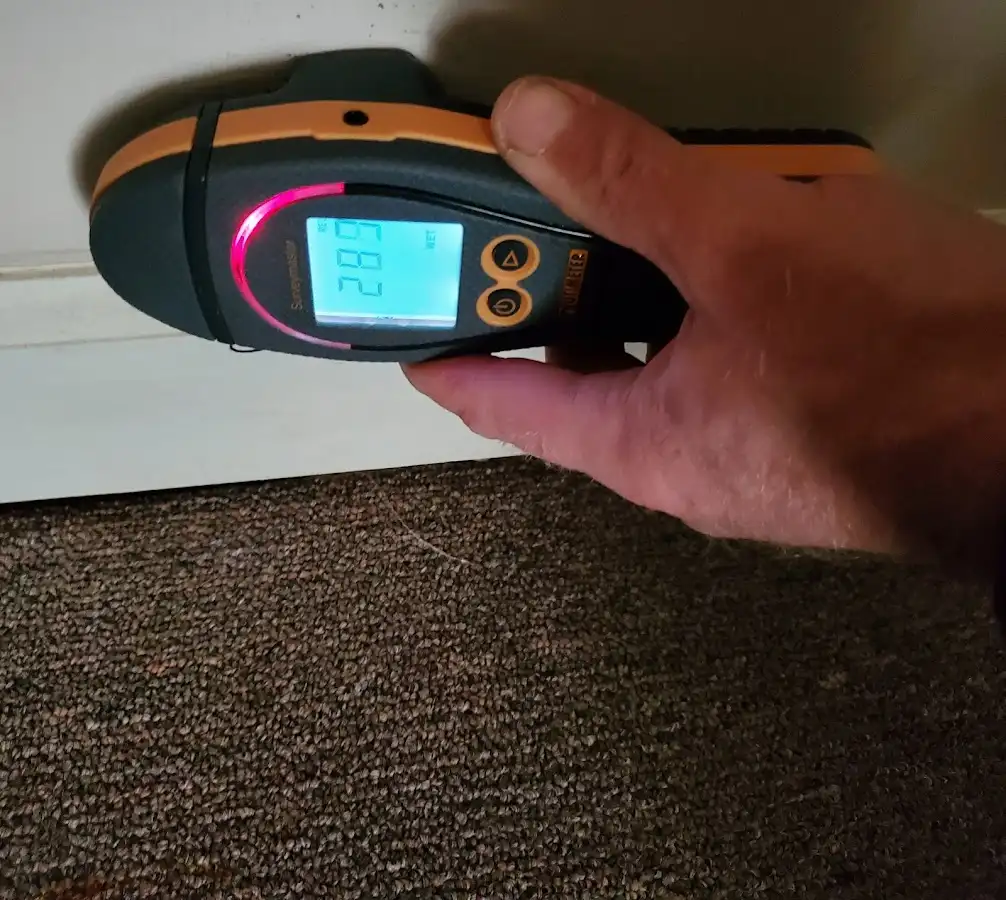 Moisture detection at baseboard during Storm Damage Restoration in Parkwood
